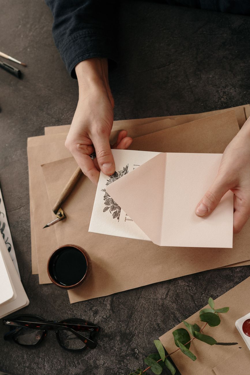 person holding white printer paper