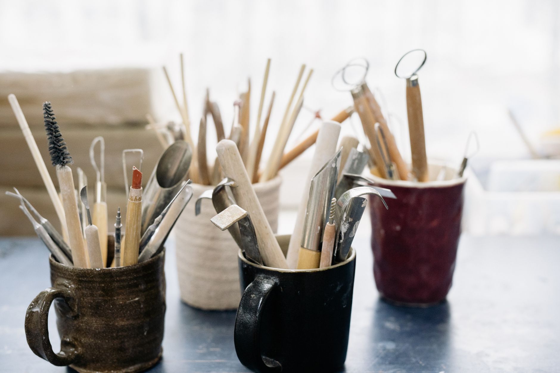 artistic tools in jars on table