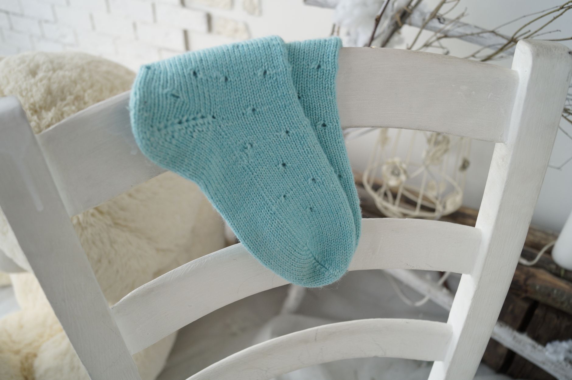 blue knit socks on white wooden chair