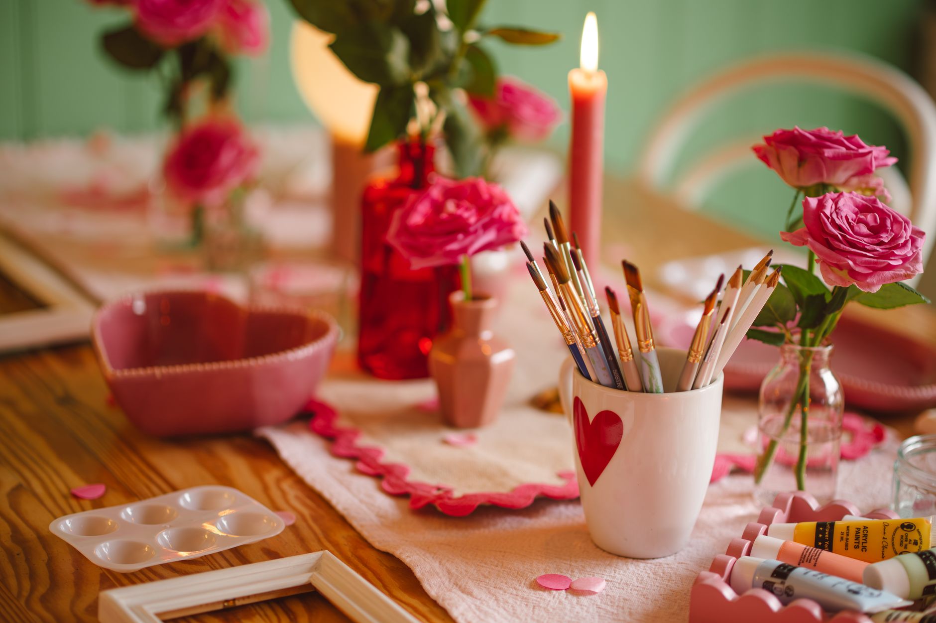 romantic craft setup with pink roses and candles